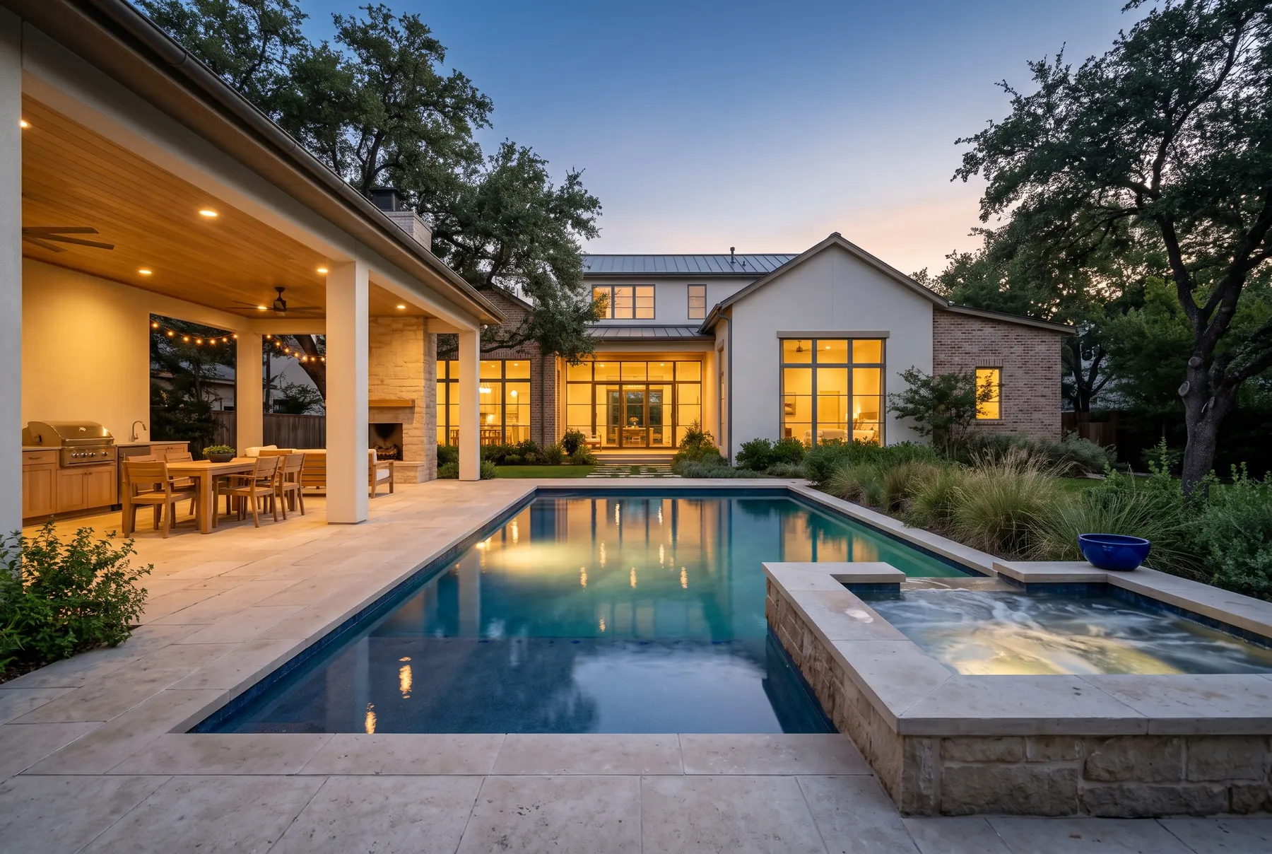 A finished backyard with a glowing pool and covered patio at dusk (concept rendering)